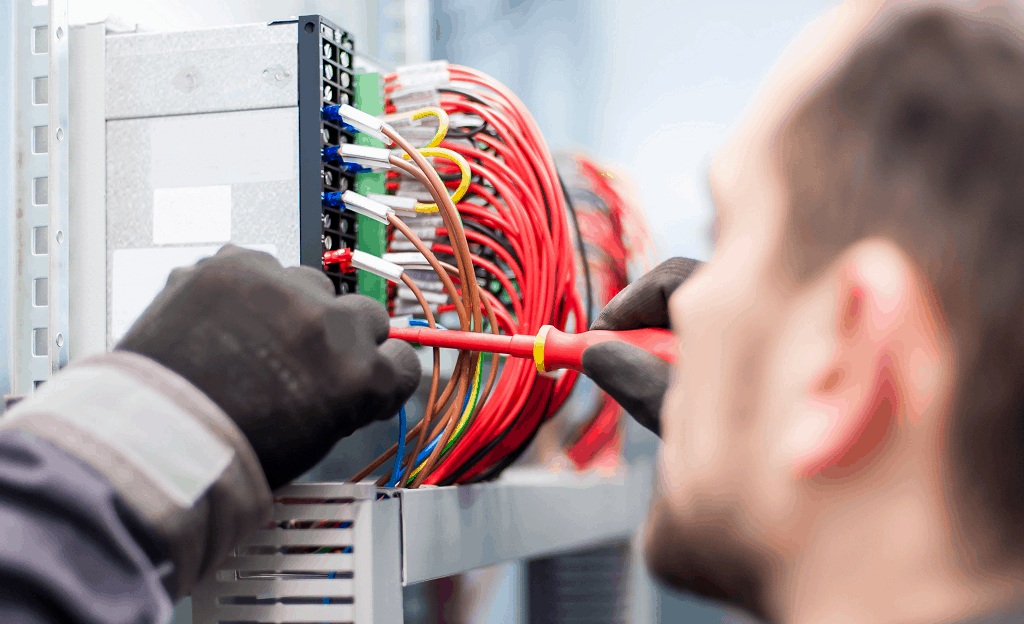 Food equipment technician conducting electrical service