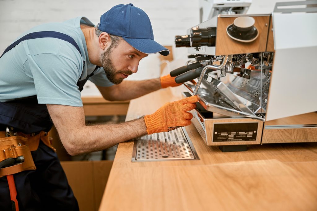 Certified repair technician fixing an espresso machine-Right to repair act